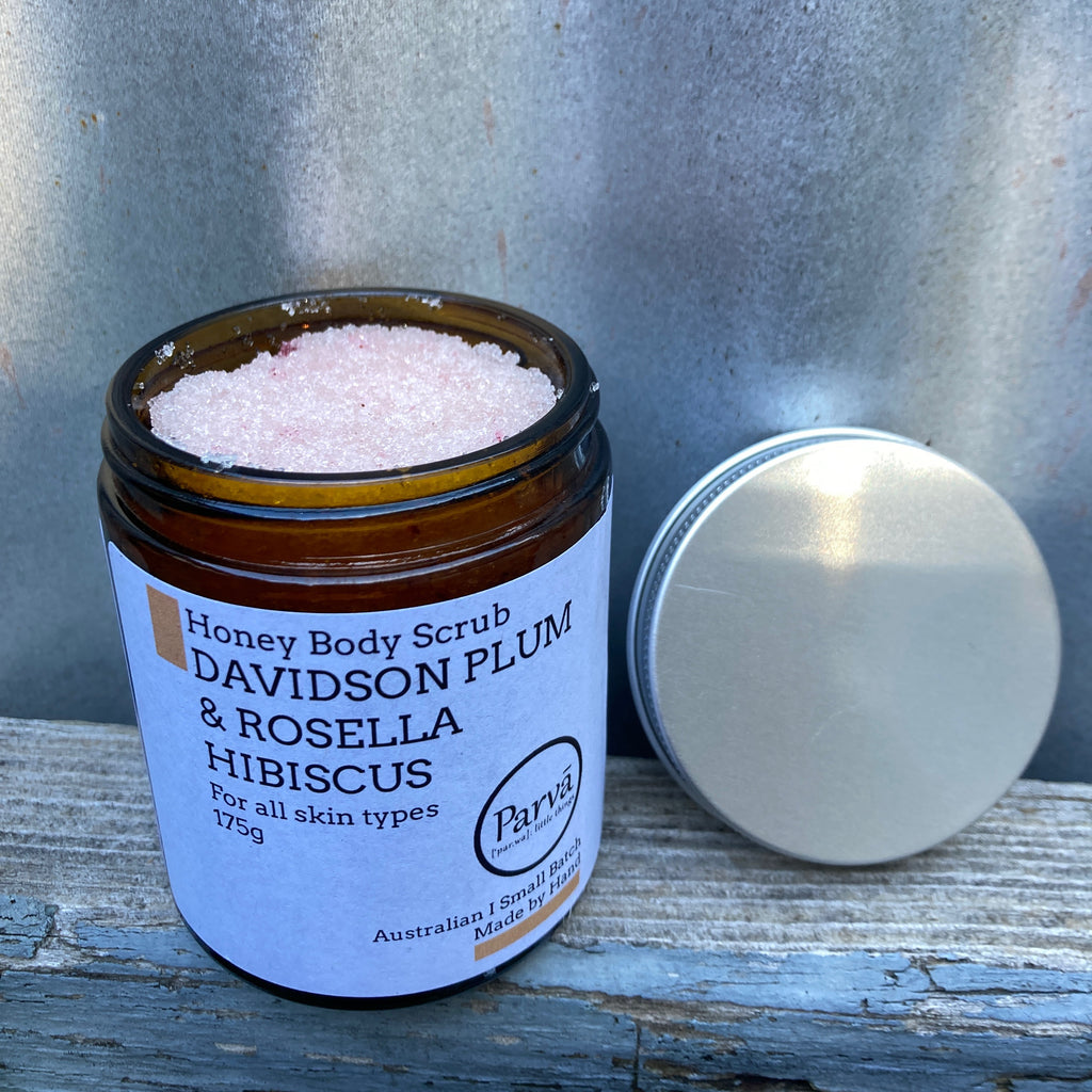An open jar of handmade Parva Honey Body Scrub with Davidson Plum and Rosella Hibiscus from Asiki Australia.