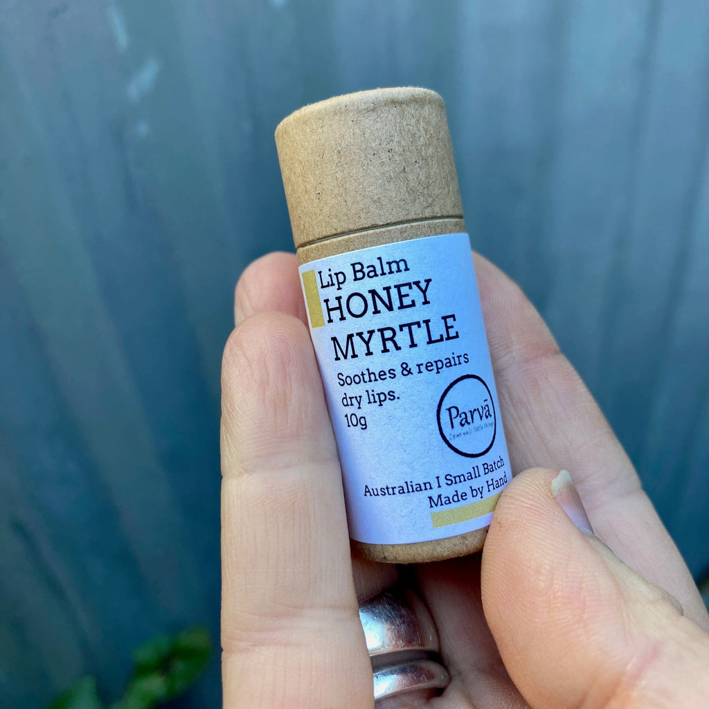 A photo of a little cardboard tube of Honey Myrtle Natural Lip Balm by Kirsty Mootz of Parva Little Things organic skincare. Available at Asiki.