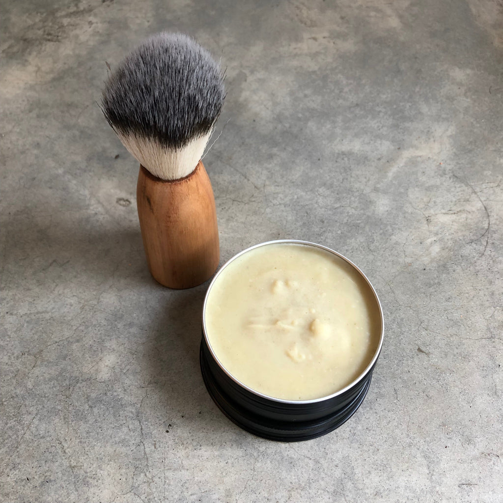 Vegan Mr Smooth Shaving Soap in a tin, pictured with a vegan Shaving Brush with wooden handle.