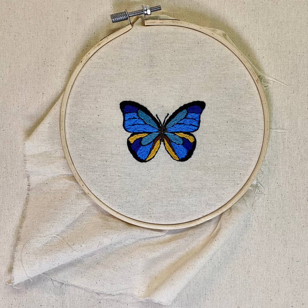 Photo of a Visible Mending Sewing Embroidery  Kit depicting a blue butterfly design. Available at Asiki, Sydney, Australia.  